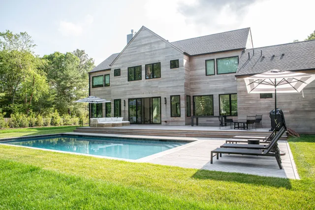 a view of house with swimming pool yard and outdoor seating