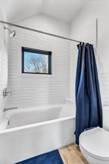 a bedroom with a bed and flat screen tv