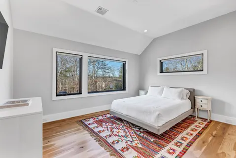 a bathroom with a toilet sink vanity and mirror
