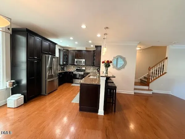 a kitchen with refrigerator and window