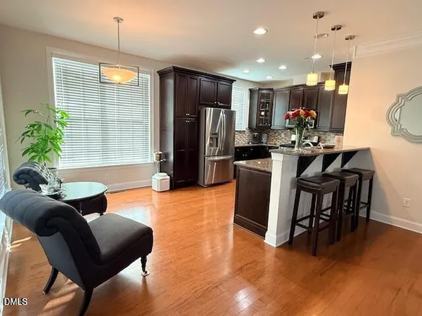 a dining room with furniture a mirror and wooden floor