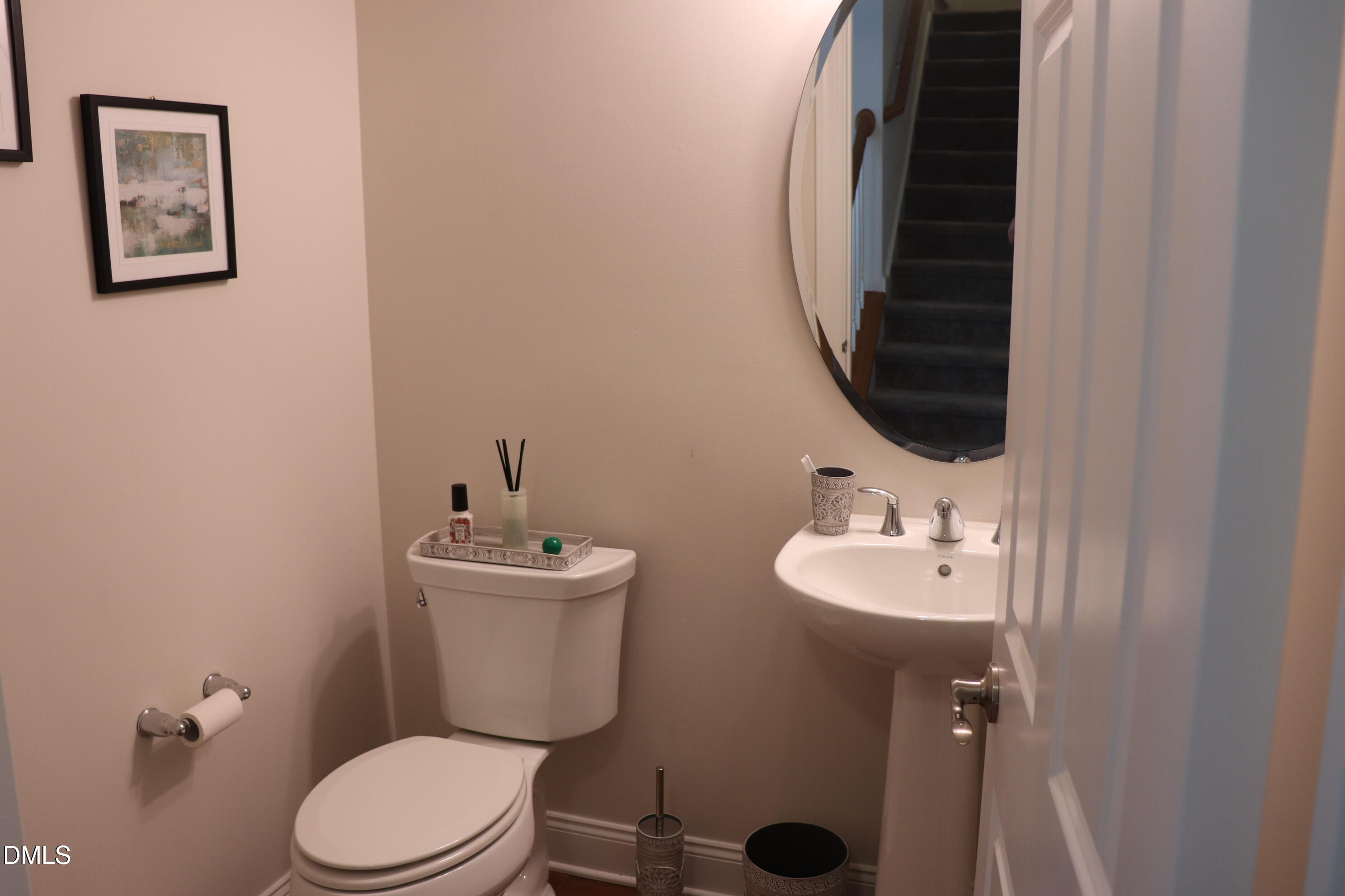 10510 Sablewood Drive, Unit 116 Raleigh, NC 27617 - Photo 20 of 47 a bathroom with a toilet a sink and mirror