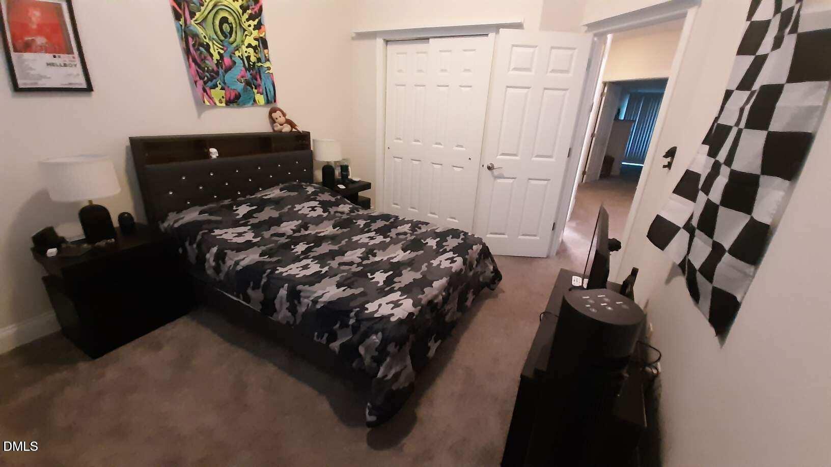 10510 Sablewood Drive, Unit 116 Raleigh, NC 27617 - Photo 33 of 47 a bed sitting in a bedroom next to a bathroom