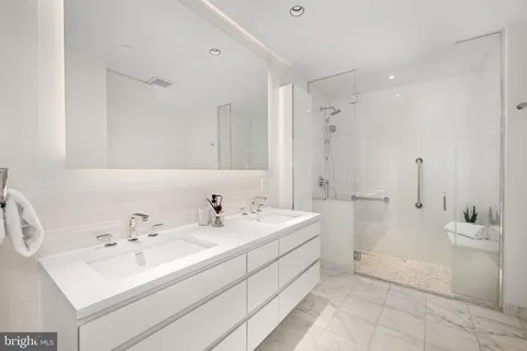 a view of bathroom with a sink mirror and a bathtub