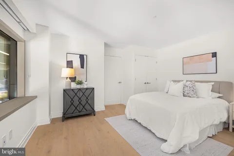 a bedroom with a bed and painting on the wall