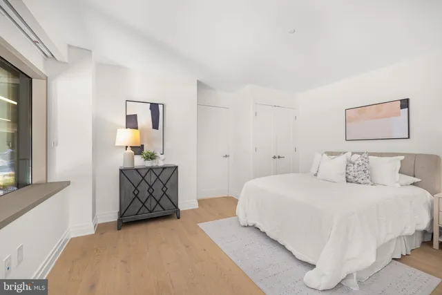 a bedroom with a bed and painting on the wall