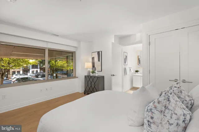 a bedroom with a bed and a large window