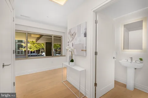a view of an entryway with wooden floor