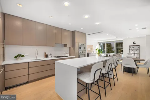 a kitchen with stainless steel appliances kitchen island granite countertop a sink and cabinets