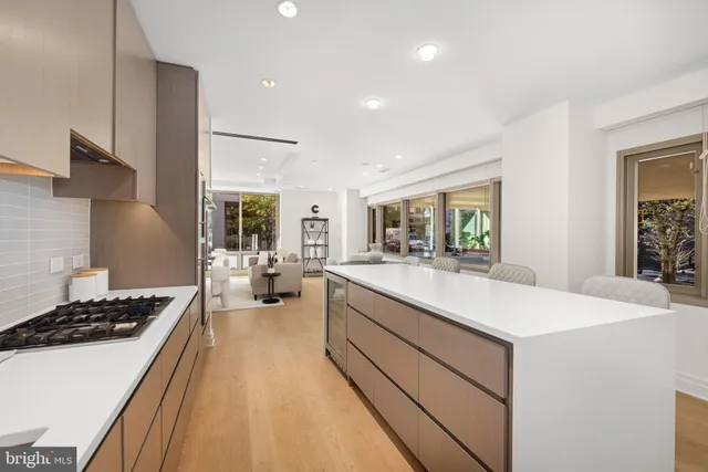 a large white kitchen with sink stove and refrigerator