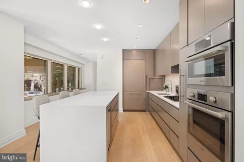 a kitchen with stainless steel appliances a sink stove and refrigerator