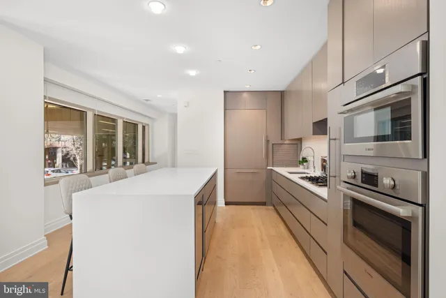 a kitchen with stainless steel appliances a sink stove and refrigerator