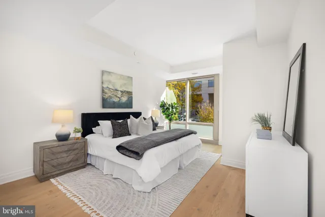 a spacious bedroom with a large bed and a large window