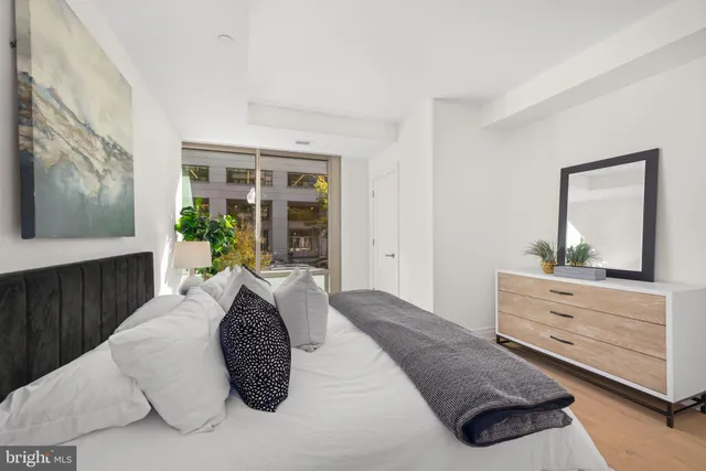 a bedroom with a bed and a dresser