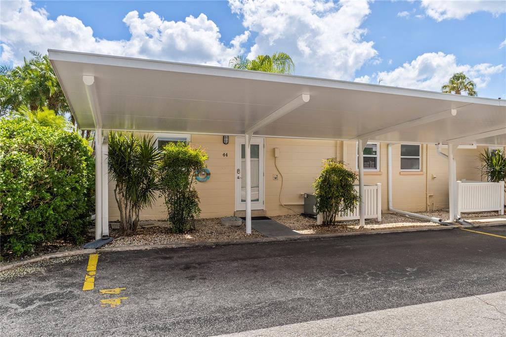 5830 Midnight Pass Road, Unit 44 Sarasota, FL 34242 - Photo 1 of 1 a front view of a house with garden