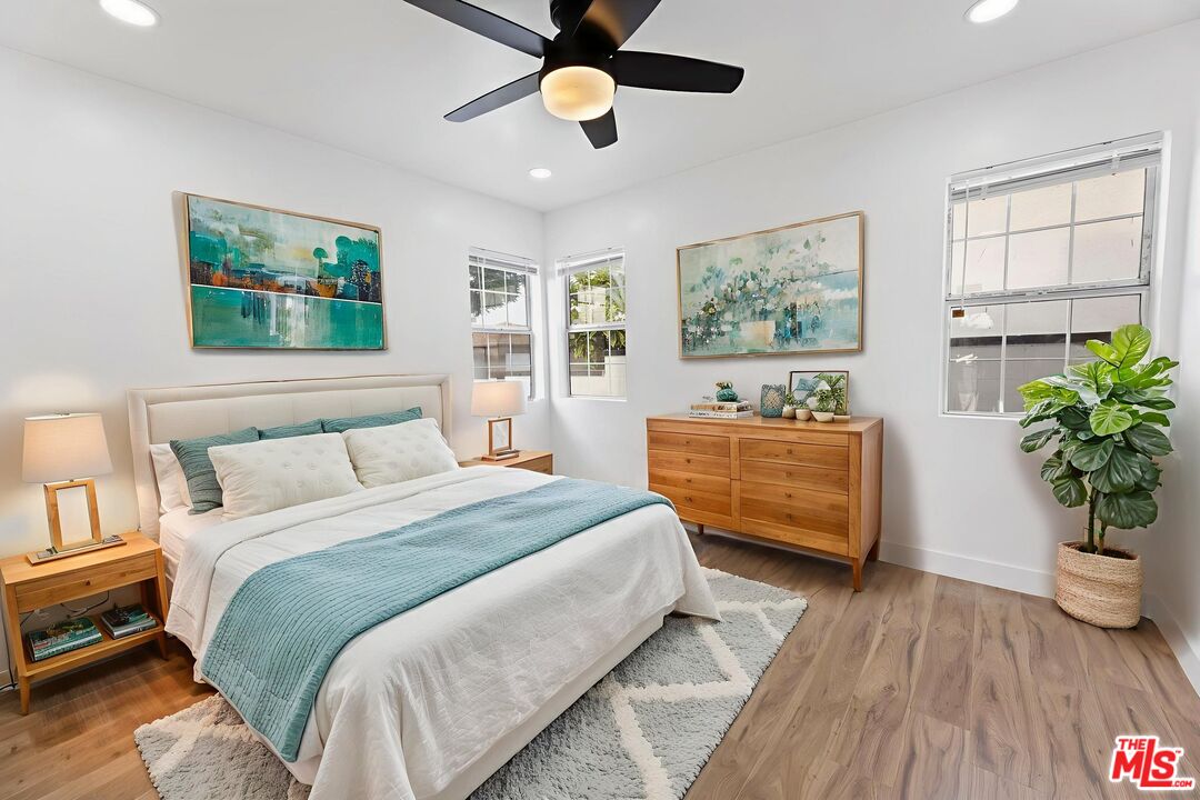 6833 Crafton Avenue Bell, CA 90201 - Photo 18 of 33 a bedroom with a bed a dresser and wooden floor