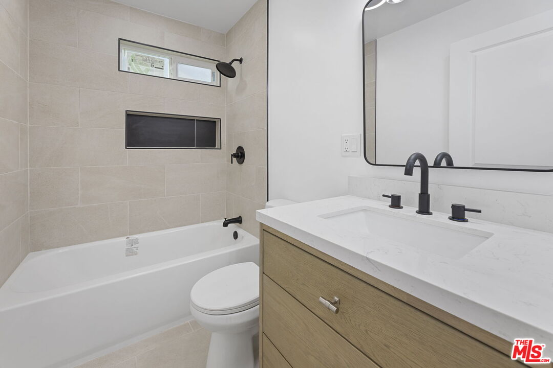 6833 Crafton Avenue Bell, CA 90201 - Photo 21 of 33 a bathroom with a sink a toilet and bathtub