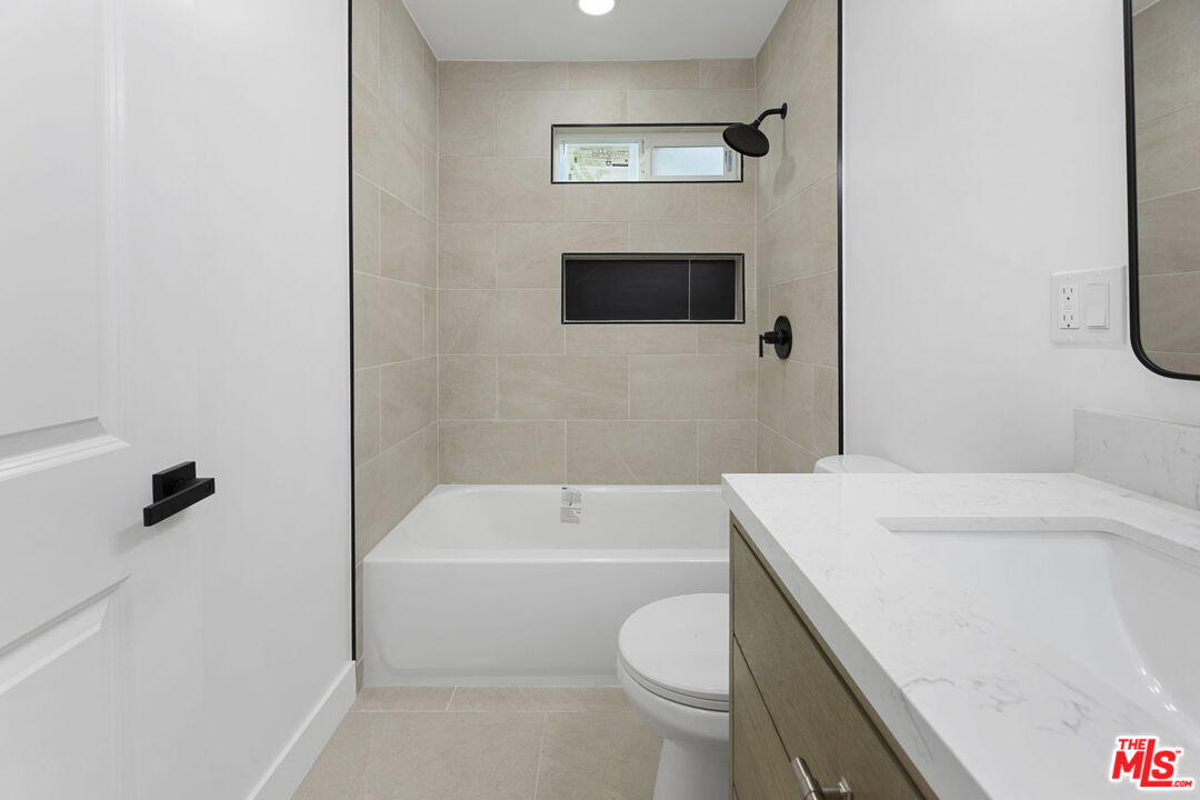 6833 Crafton Avenue Bell, CA 90201 - Photo 22 of 33 a bathroom with a sink a toilet and bathtub