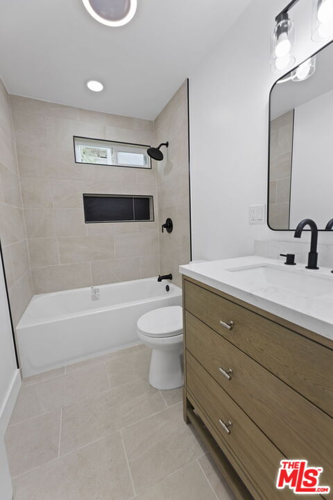 6833 Crafton Avenue Bell, CA 90201 - Photo 23 of 33 a bathroom with a sink a toilet and a bathtub