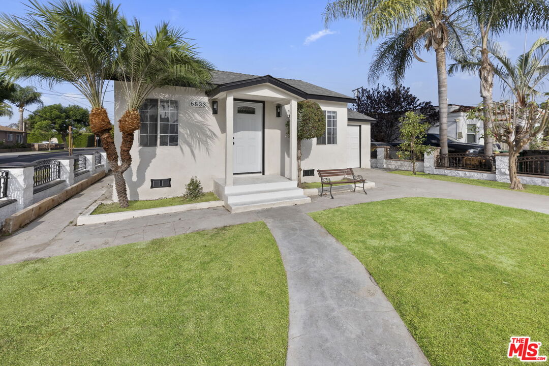 6833 Crafton Avenue Bell, CA 90201 - Photo 3 of 33 a front view of a house with garden and porch