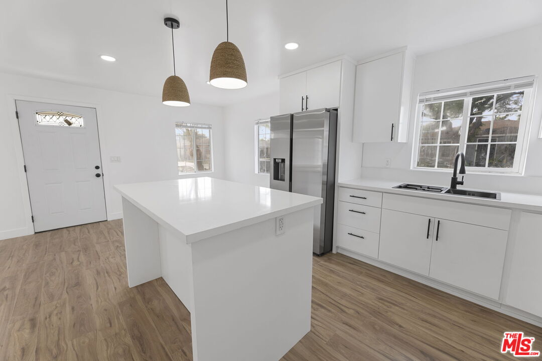 6833 Crafton Avenue Bell, CA 90201 - Photo 7 of 33 a kitchen with a sink stainless steel appliances and window