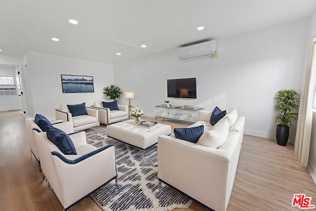 6833 Crafton Avenue Bell, CA 90201 - Photo 9 of 33 a living room with furniture a wooden floor and a flat screen tv