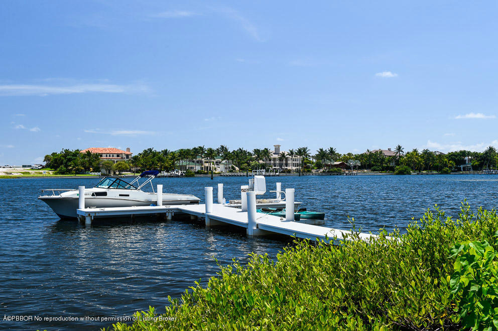 1680 Lands End Road Manalapan, FL 33462 - Photo 2 of 15 a view of a lake with boats and trees in the background
