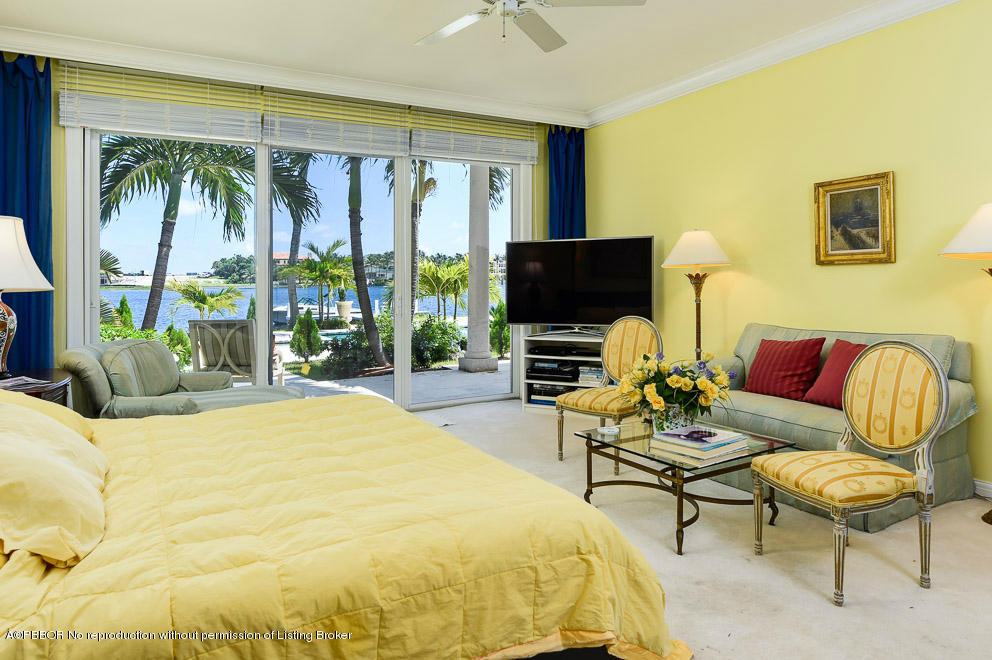 1680 Lands End Road Manalapan, FL 33462 - Photo 12 of 15 a spacious bedroom with a bed and a flat screen tv