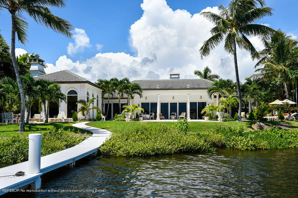 1680 Lands End Road Manalapan, FL 33462 - Photo 5 of 15 a front view of a house with a garden