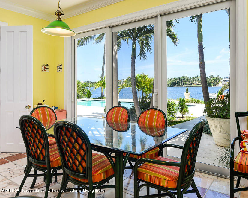 1680 Lands End Road Manalapan, FL 33462 - Photo 6 of 15 a dining room with furniture a chandelier and wooden floor