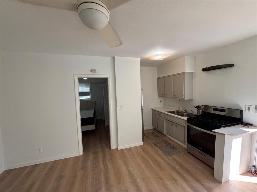 1315 Southeast 2nd Street, Unit REAR EAST Fort Lauderdale, FL 33301 - Photo 5 of 12 a kitchen with stainless steel appliances granite countertop a stove and a refrigerator