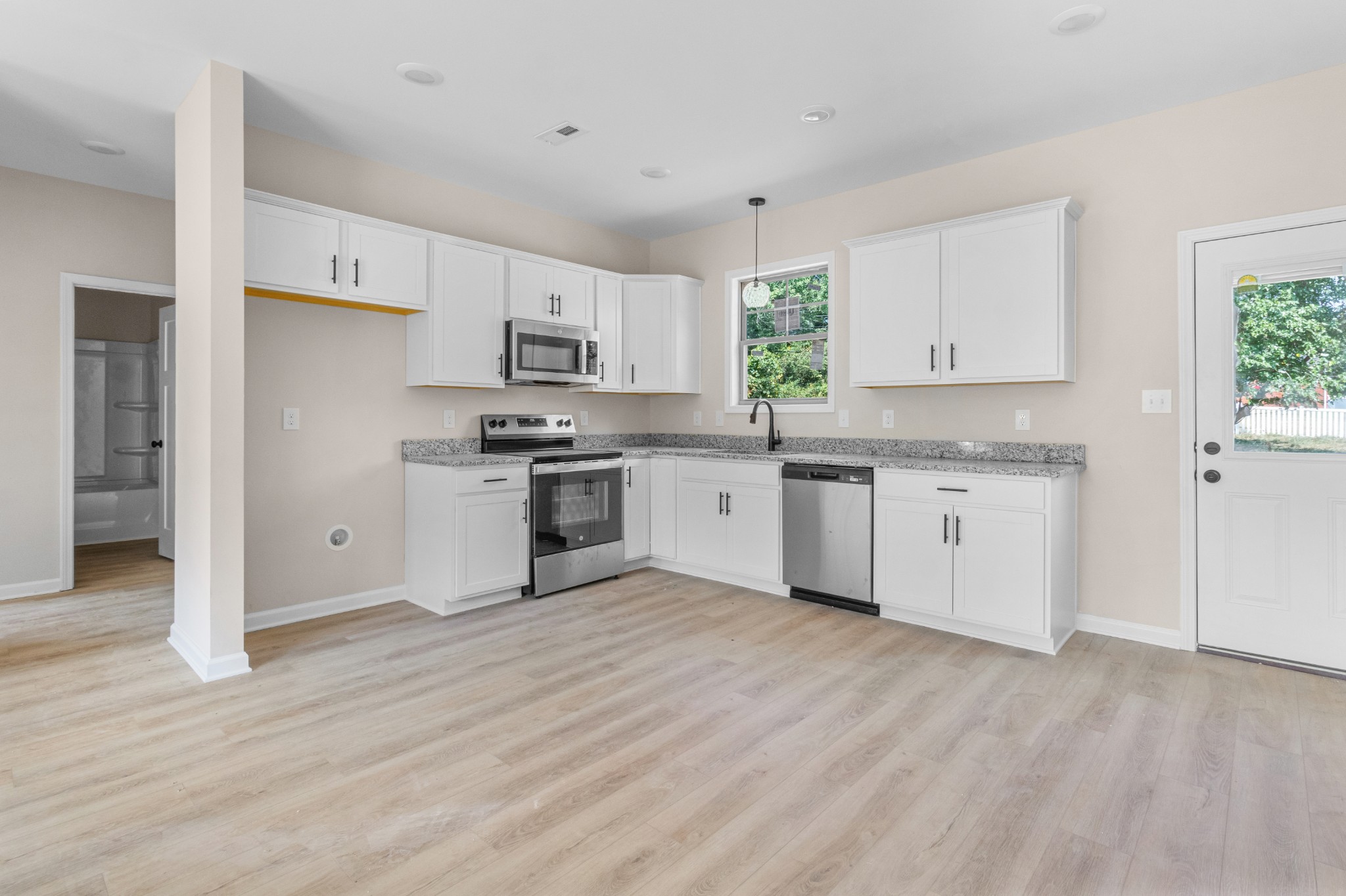 11 Donelson Drive Clarksville, TN 37042 - Photo 8 of 15 a kitchen with stainless steel appliances granite countertop a stove top oven a sink dishwasher and a refrigerator with wooden floor