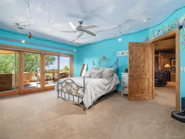 a spacious bedroom with a large bed and a chandelier