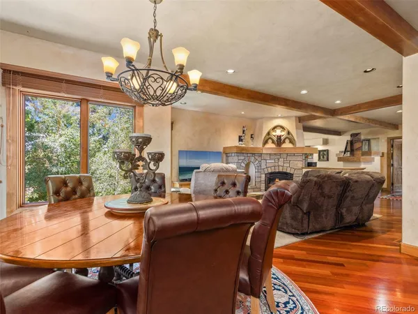 a living room with fireplace furniture and a chandelier