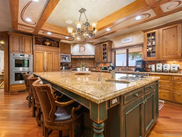 a kitchen with a table chairs and wooden floor