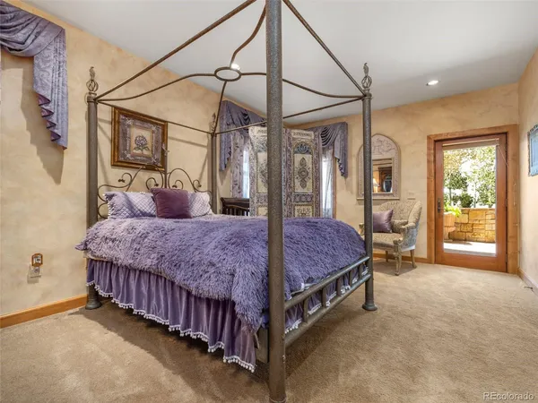 a spacious bedroom with a bed and ceiling fan