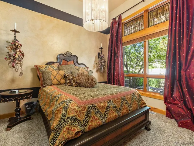 a en suite bathroom with a granite countertop sink and a large mirror