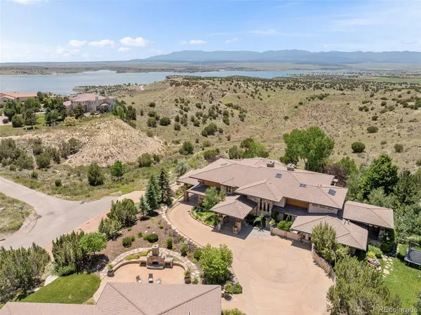 a view of a house with pool and chairs