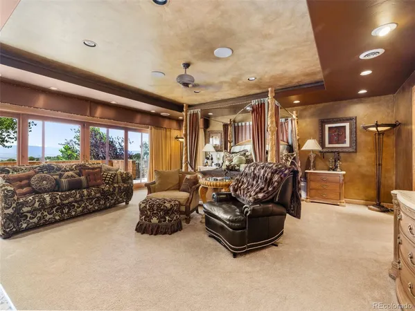 a living room with furniture gym equipment and large windows