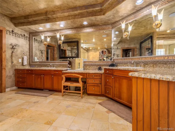 a large kitchen with stainless steel appliances granite countertop a stove and cabinets