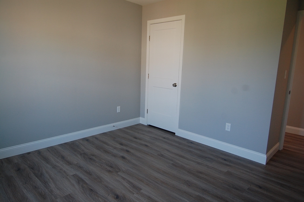 9 Bolton Road, Unit S Dartmouth, MA 02748 - Photo 9 of 19 a view of an empty room with wooden floor and entrance