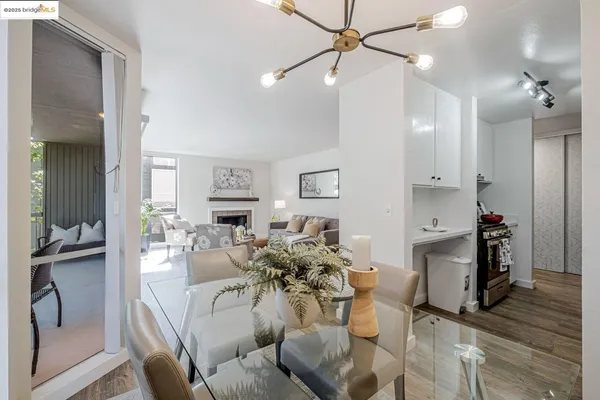 a view of a dining room with furniture wooden floor and a chandelier