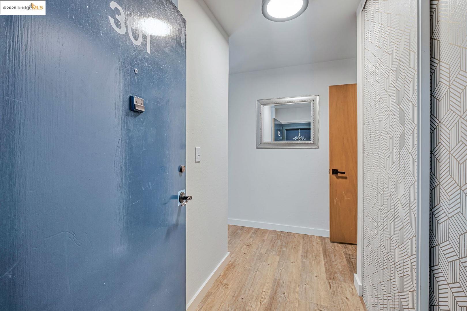 2700 Le Conte Avenue, Unit 301 Berkeley, CA 94709 - Photo 16 of 22 a view of a hallway with wooden floor and a bathroom