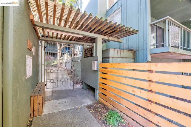 a backyard of a house with barbeque oven table and chairs