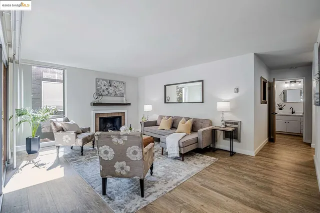 a living room with furniture large window and a fireplace