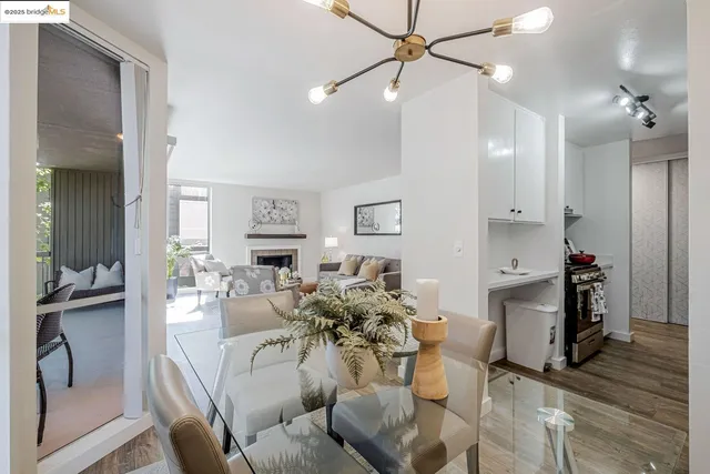 a view of a dining room with furniture wooden floor and a chandelier