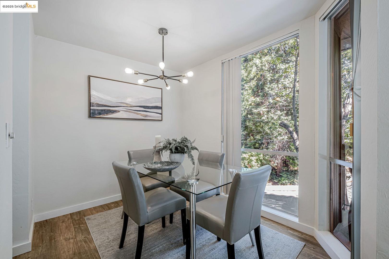 2700 Le Conte Avenue, Unit 301 Berkeley, CA 94709 - Photo 8 of 22 a dining room with furniture a chandelier and wooden floor