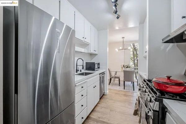 a kitchen with stainless steel appliances a refrigerator and a stove