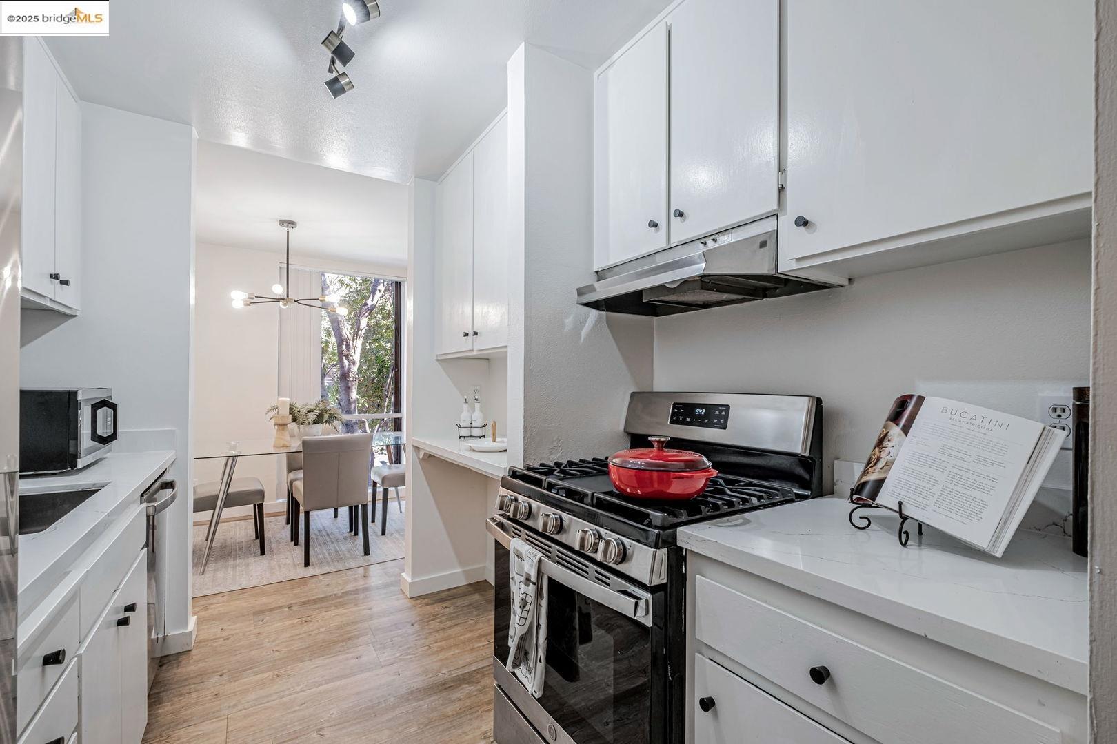 2700 Le Conte Avenue, Unit 301 Berkeley, CA 94709 - Photo 10 of 22 a kitchen with a stove and cabinets