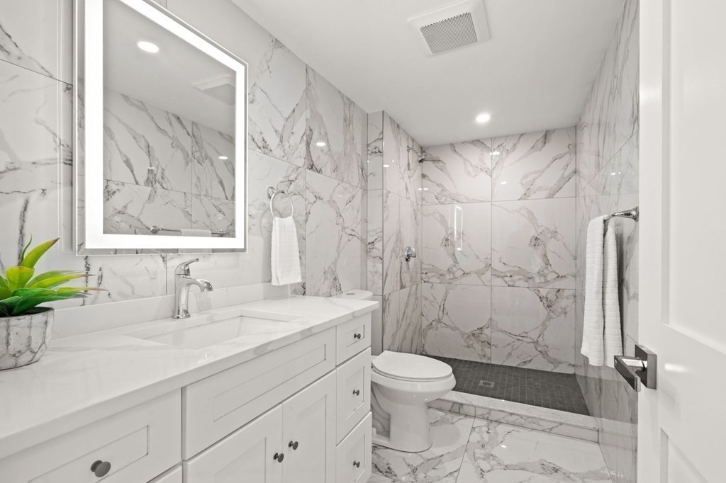 19 Cold Spring Road, Unit S North Reading, MA 01864 - Photo 17 of 30 a bathroom with a shower sink vanity mirror and toilet